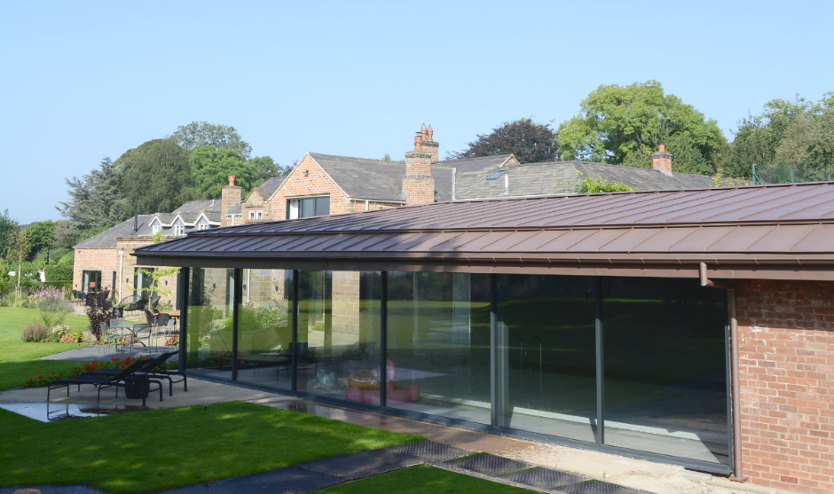 Zinc roof over a swimming pool in Cheshire - matching rainwater goods